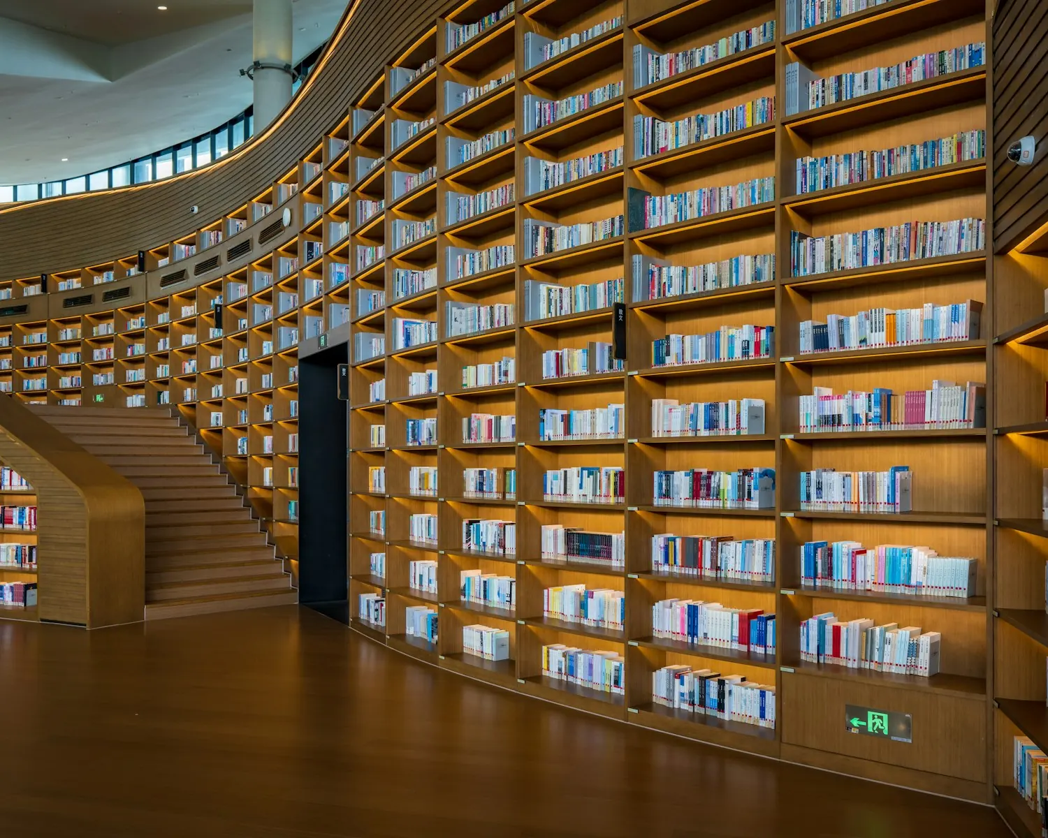 Curved wooden library shelves filled with books