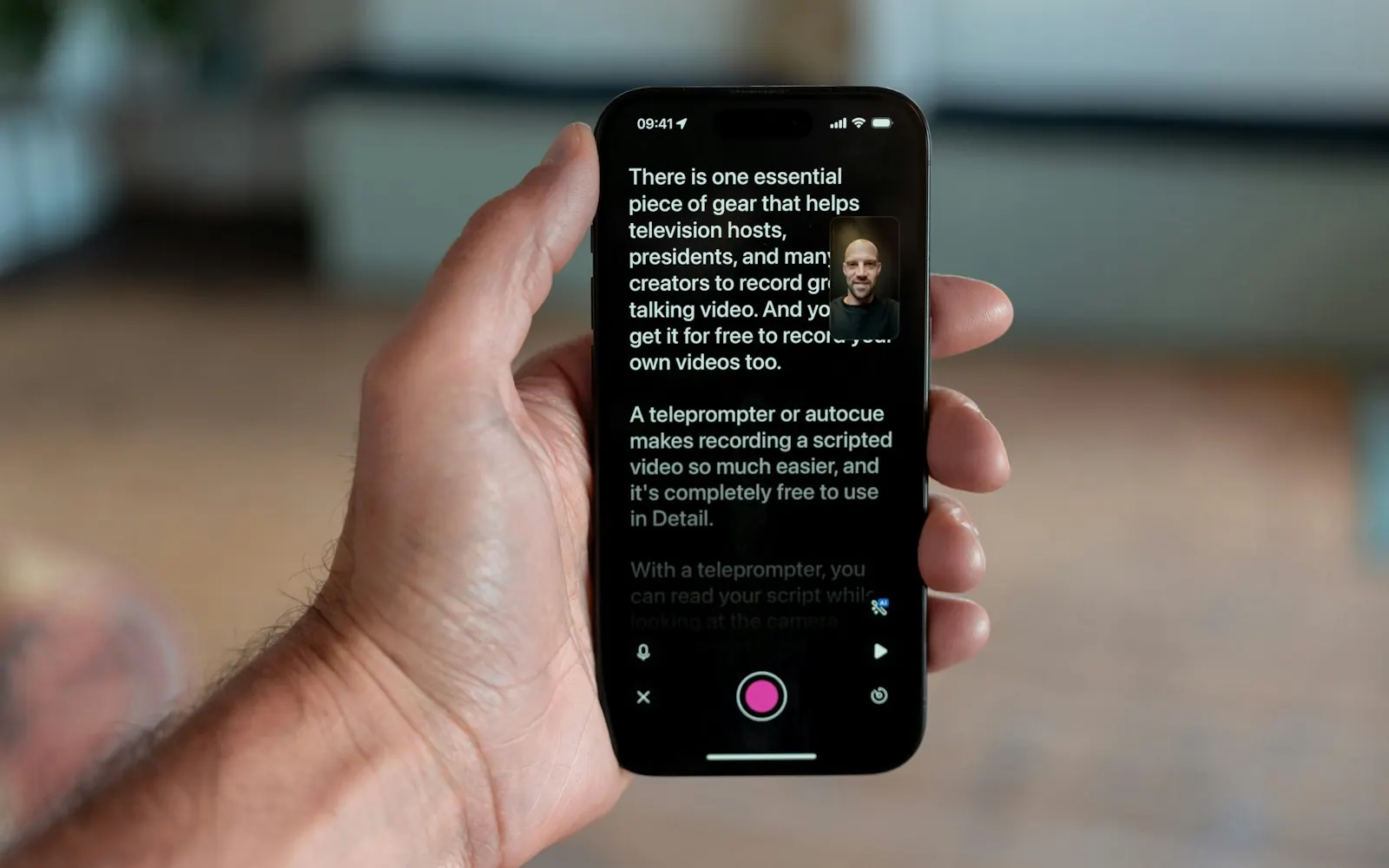 A hand holding a phone running a teleprompter app while filming social content in Brisbane