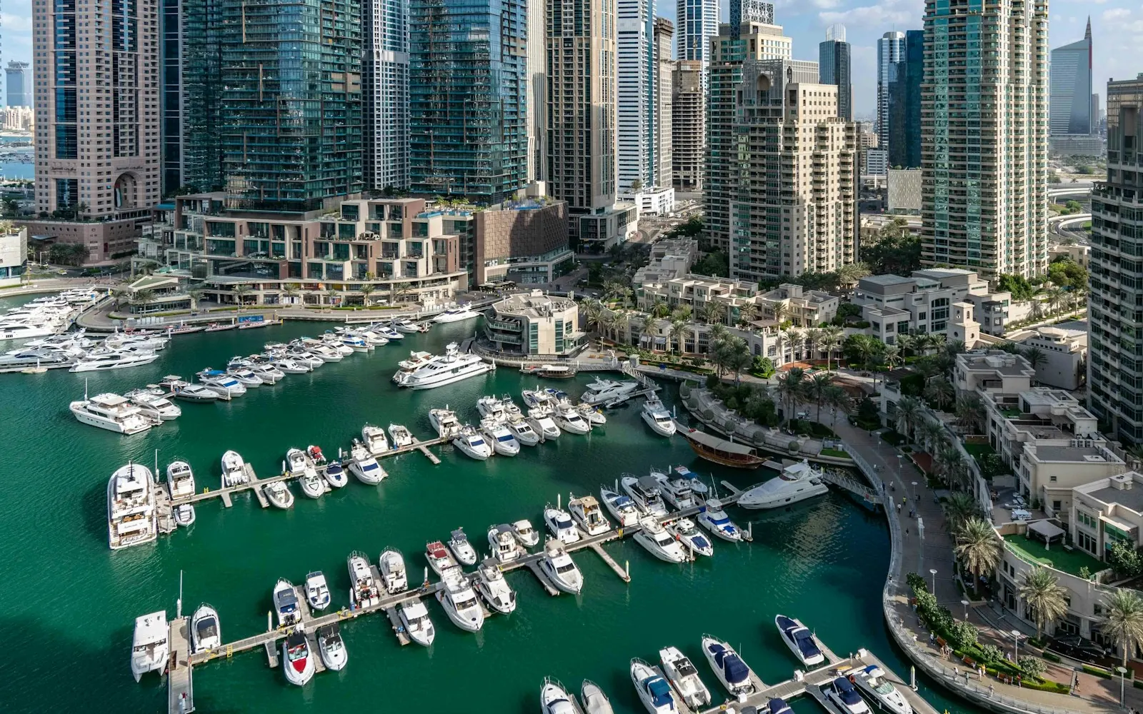 Aerial view of yachts moored in Dubai Marina below rows of residential towers