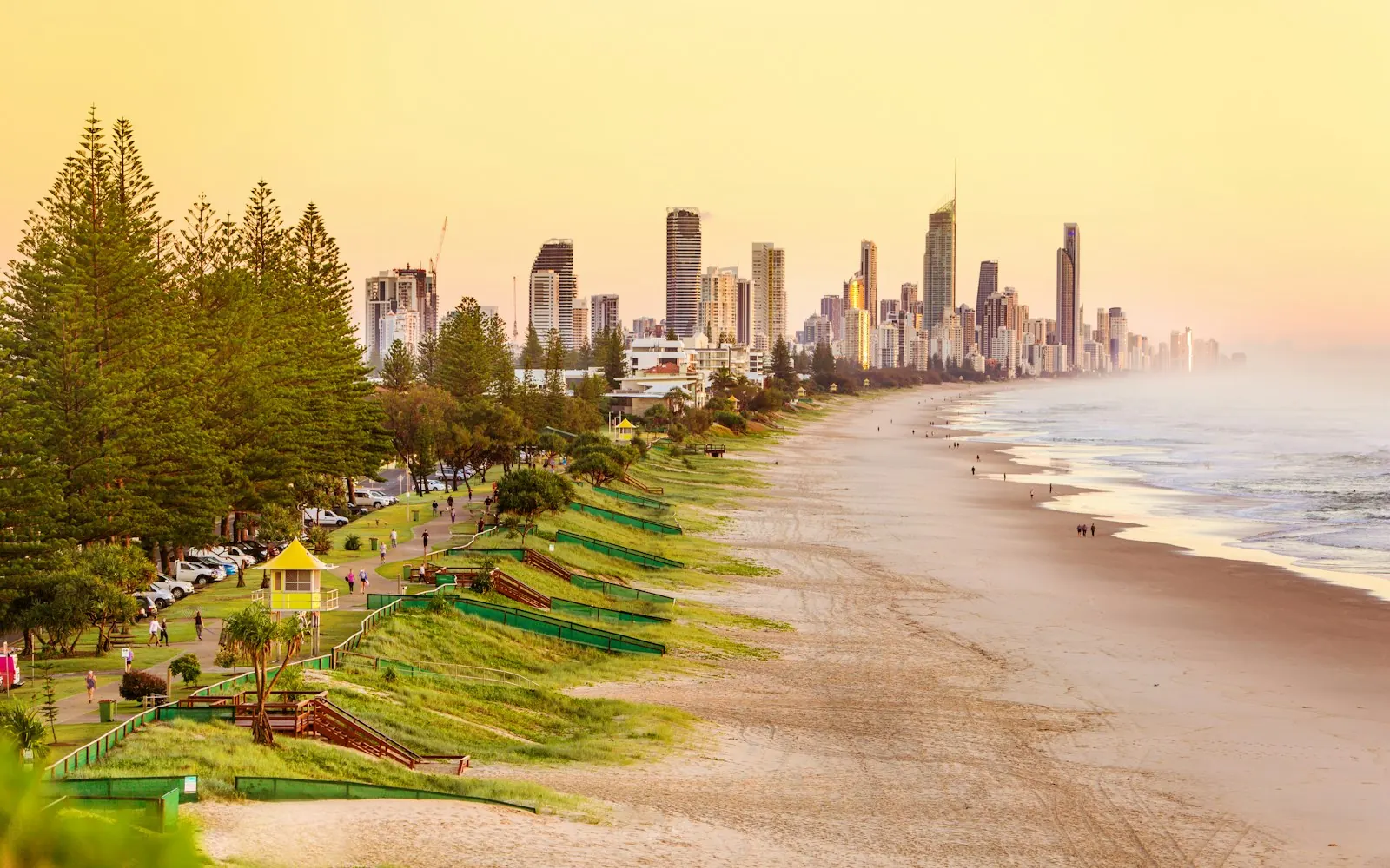 Gold Coast skyline at Surfers Paradise with high-rise towers along the beach and the surf in the foreground
