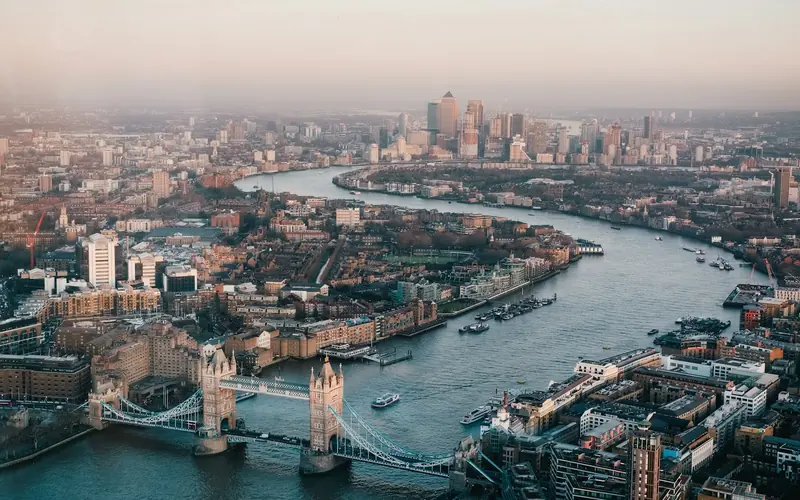 London skyline over the River Thames with the City of London towers and Tower Bridge at dusk