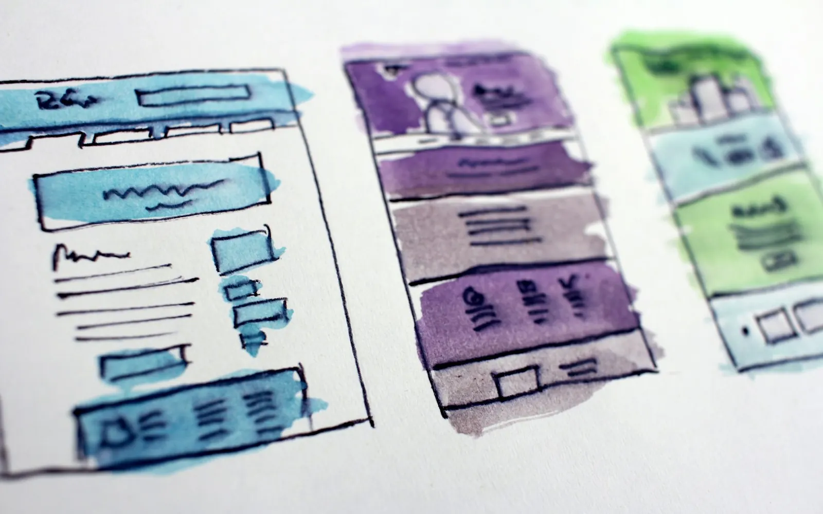 Watercolour sketches of website wireframe layouts, showing page structures planned before a web design build