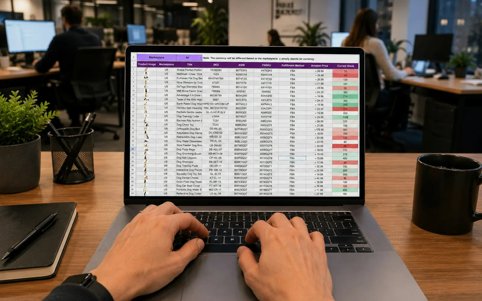 Hands working on a laptop showing a keyword spreadsheet in an open plan office