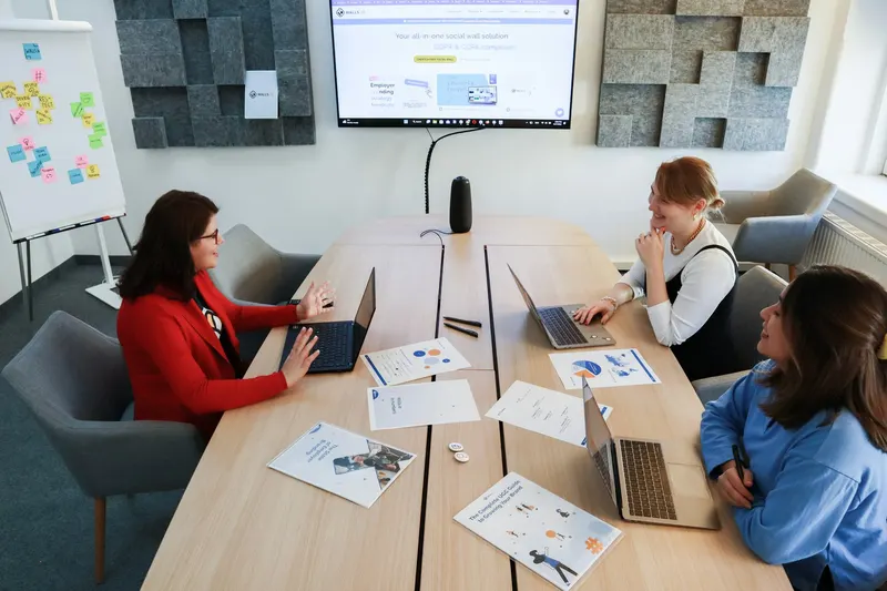 Team reviewing printed campaign reports in a bright meeting room