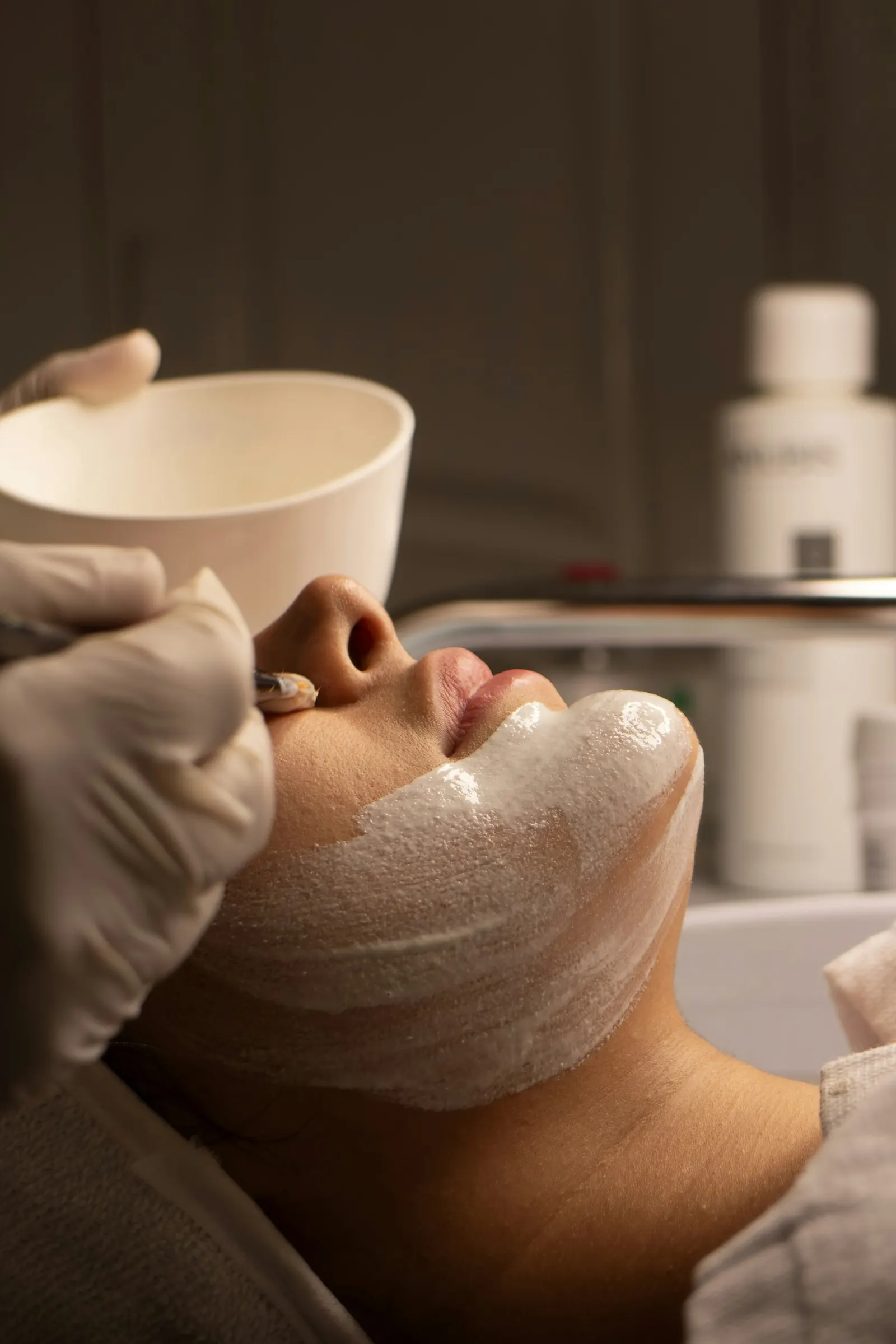 A practitioner giving a facial treatment